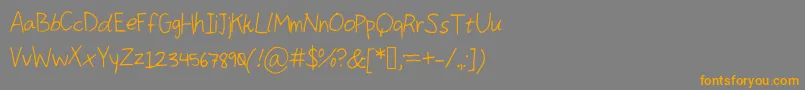 フォントComingKiddo – オレンジの文字は灰色の背景にあります。