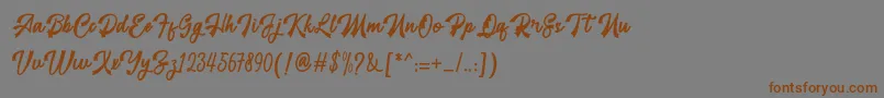 フォントrestyla – 茶色の文字が灰色の背景にあります。