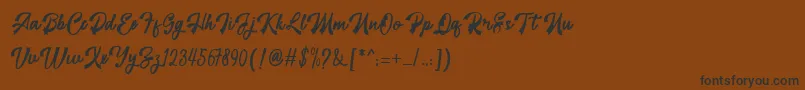 フォントrestyla – 黒い文字が茶色の背景にあります