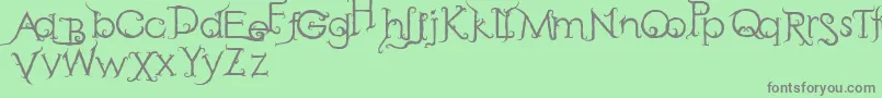 RetakSeribu-fontti – harmaat kirjasimet vihreällä taustalla