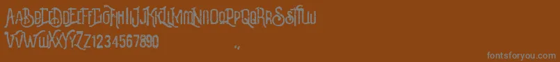 Revalina-fontti – harmaat kirjasimet ruskealla taustalla