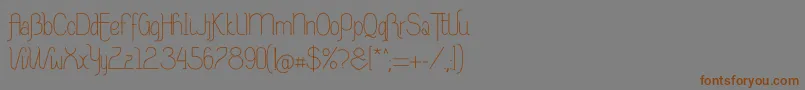 フォントRiasAltasRibadeoLGtipos Nor – 茶色の文字が灰色の背景にあります。