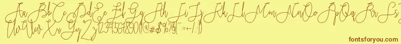 フォントRieesflomeo – 茶色の文字が黄色の背景にあります。