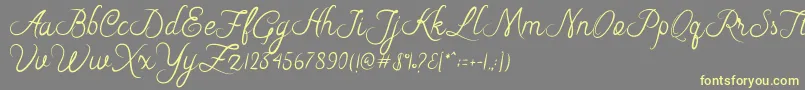Riska Script Font – Yellow Fonts on Gray Background