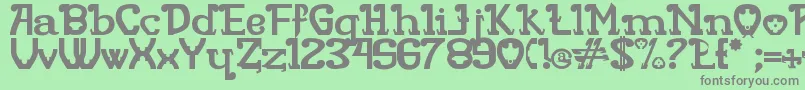 Rita Mouse-fontti – harmaat kirjasimet vihreällä taustalla