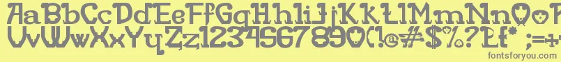 Rita Mouse-fontti – harmaat kirjasimet keltaisella taustalla