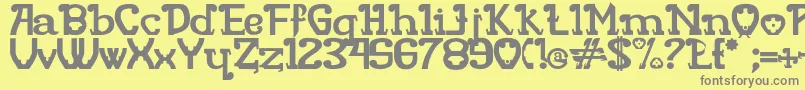 RITAMOUS-Schriftart – Graue Schriften auf gelbem Hintergrund