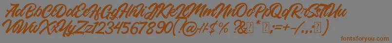 フォントRoland – 茶色の文字が灰色の背景にあります。