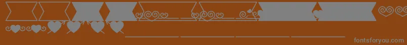 Шрифт Romantine Dingbats – серые шрифты на коричневом фоне