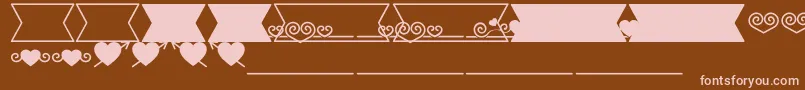 Romantine Dingbats-fontti – vaaleanpunaiset fontit ruskealla taustalla
