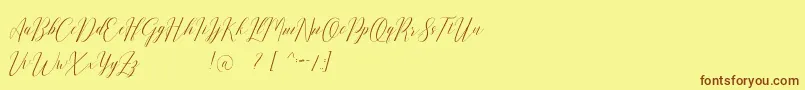 フォントRomarya dafont – 茶色の文字が黄色の背景にあります。