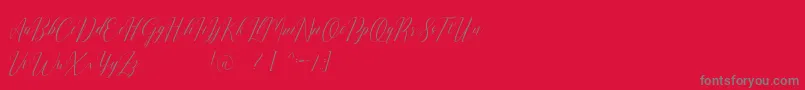Romarya dafont-fontti – harmaat kirjasimet punaisella taustalla