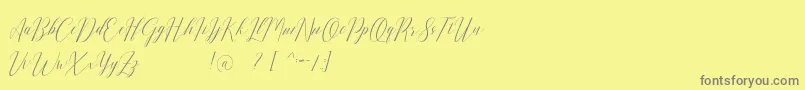 Romarya dafont-fontti – harmaat kirjasimet keltaisella taustalla