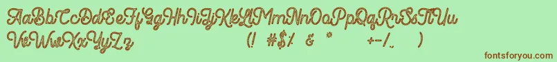 Fonte Romedhal Script Stamp – fontes marrons em um fundo verde