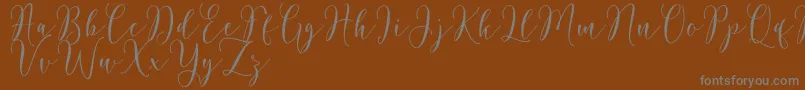 Rosetica Script Demo-Schriftart – Graue Schriften auf braunem Hintergrund