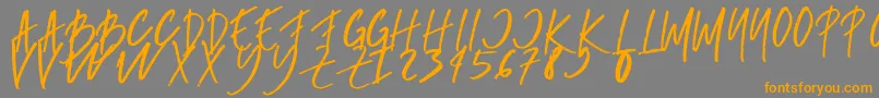 フォントrumbe – オレンジの文字は灰色の背景にあります。
