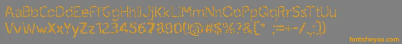 フォントruxandra – オレンジの文字は灰色の背景にあります。