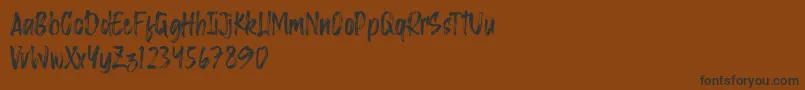 Saggacity Brush-Schriftart – Schwarze Schriften auf braunem Hintergrund