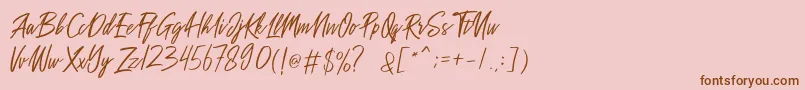 Fonte Sakoda Demo – fontes marrons em um fundo rosa