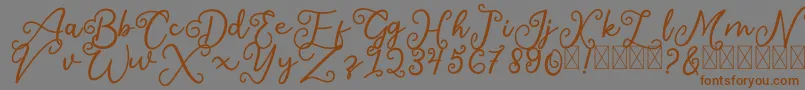 フォントSalaheFree – 茶色の文字が灰色の背景にあります。