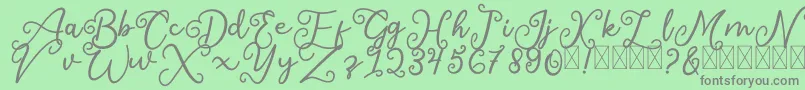SalaheFree-fontti – harmaat kirjasimet vihreällä taustalla
