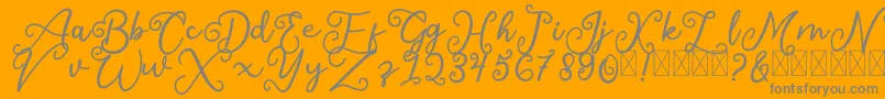Czcionka SalaheFree – szare czcionki na pomarańczowym tle
