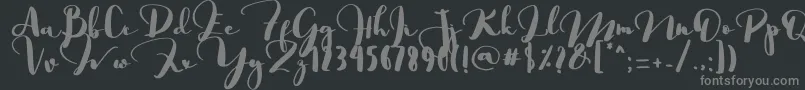 Saligra-fontti – harmaat kirjasimet mustalla taustalla