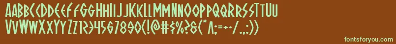 フォントOhmightyisisexpand – 緑色の文字が茶色の背景にあります。