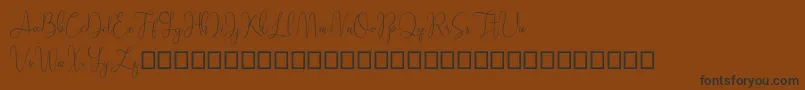 Шрифт Sathien demo – чёрные шрифты на коричневом фоне