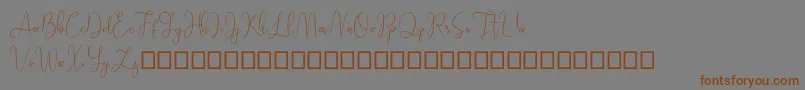 フォントSathien demo – 茶色の文字が灰色の背景にあります。