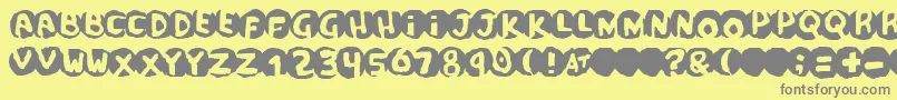 フォントscandal – 黄色の背景に灰色の文字