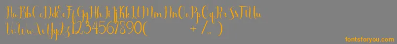 フォントScooter Free – オレンジの文字は灰色の背景にあります。
