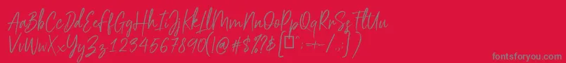 フォントScriptyca – 赤い背景に灰色の文字