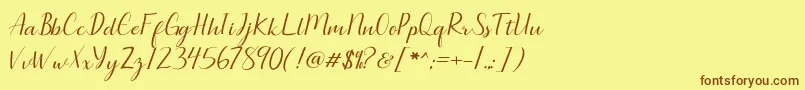 フォントSeullanga script – 茶色の文字が黄色の背景にあります。