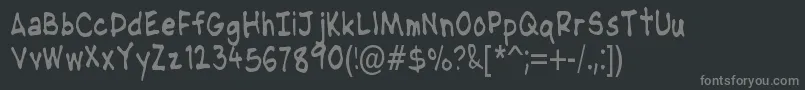 Fonte NipcensHandwritingCondensed – fontes cinzas em um fundo preto