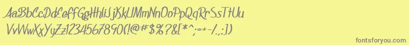 SF Foxboro Script Bold-fontti – harmaat kirjasimet keltaisella taustalla