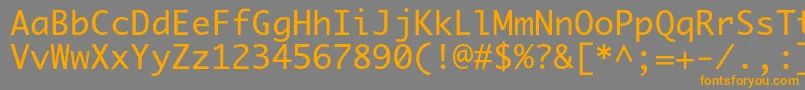 フォントPriamojc – オレンジの文字は灰色の背景にあります。