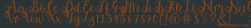 shabila Font – Brown Fonts on Black Background