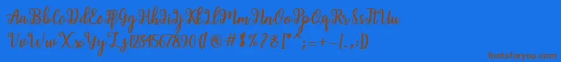 Shaila Script-fontti – ruskeat fontit sinisellä taustalla
