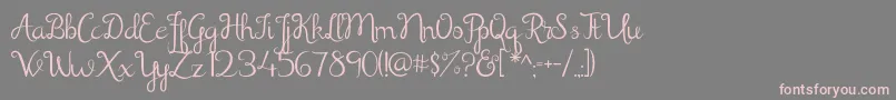 フォントShathika – 灰色の背景にピンクのフォント