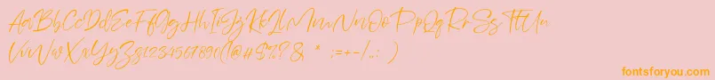 フォントSheenaz – オレンジの文字がピンクの背景にあります。