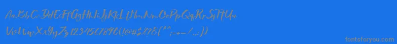 フォントShowety Brush Slant – 青い背景に灰色の文字