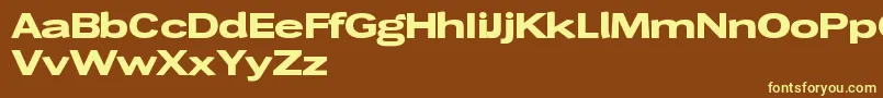 Wendelinbreitfett-fontti – keltaiset fontit ruskealla taustalla