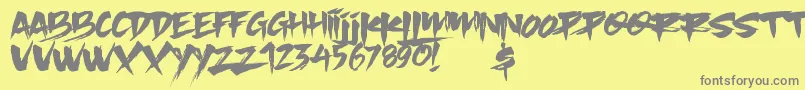 フォントSlacker Brush – 黄色の背景に灰色の文字