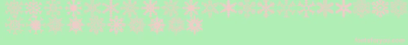 Czcionka Snowflakes St – różowe czcionki na zielonym tle