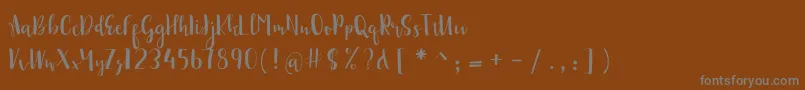 sonya demo-Schriftart – Graue Schriften auf braunem Hintergrund