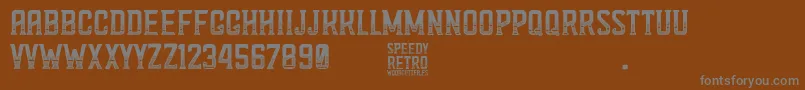 Speedy Retro-Schriftart – Graue Schriften auf braunem Hintergrund