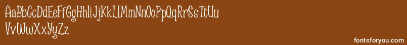 Spizzella Free font-fontti – valkoiset fontit ruskealla taustalla