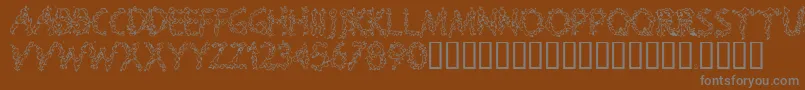 SPLOOGE -fontti – harmaat kirjasimet ruskealla taustalla