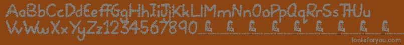 Czcionka Squiggles – szare czcionki na brązowym tle